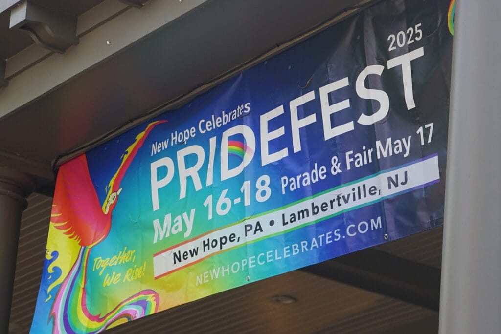 Banner reading “New Hope Celebrates PrideFest May 16–18” displayed outside a building in New Hope.