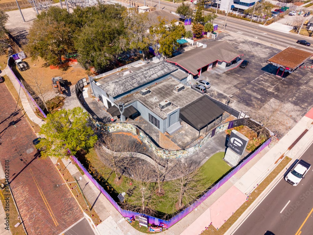 Aerial view of the Pulse Nightclub site in Orlando surrounded by memorial fencing, showing the building prior to demolition for a planned permanent memorial.