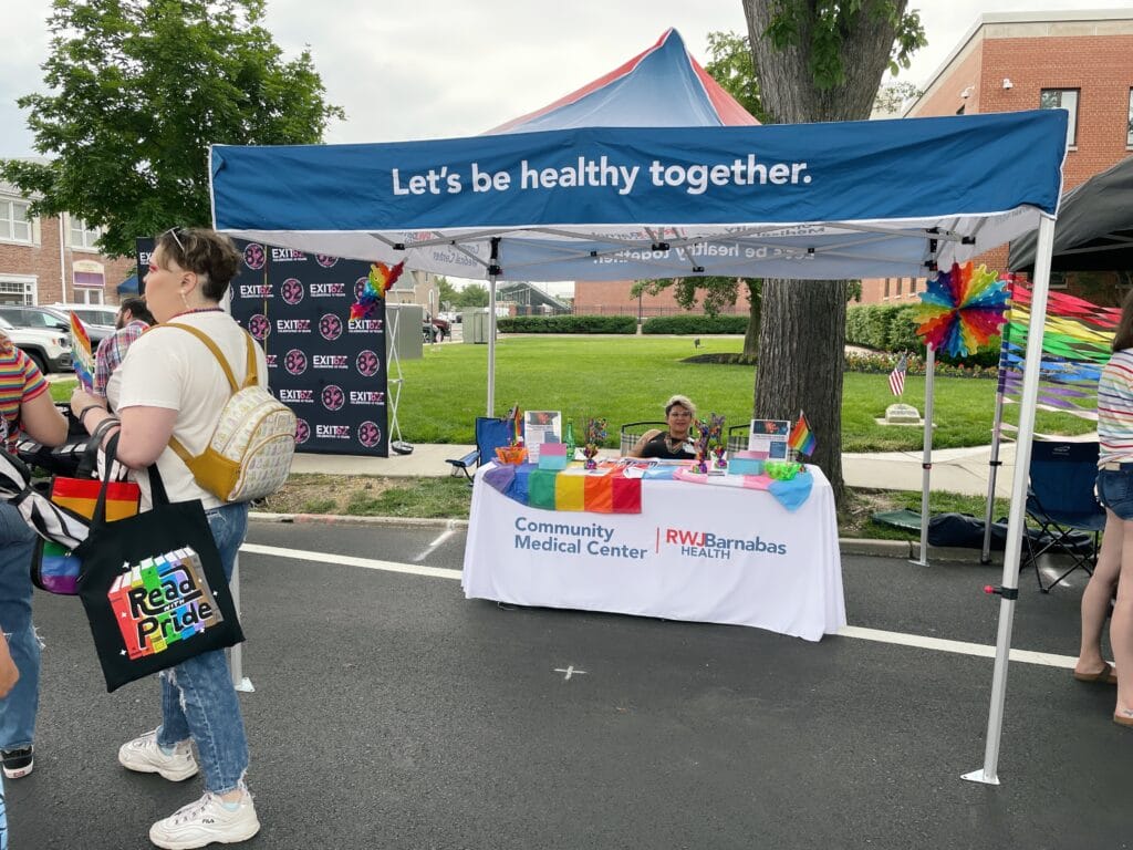 Community Medical Center and RWJBarnabas Health booth decorated with Pride flags and outreach materials at Toms River Pride.