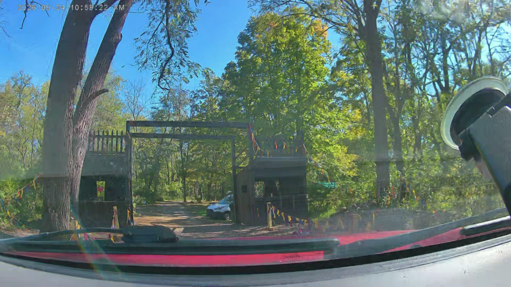 View through a windshield of Lezapalooza’s wooden campground gateway before its sign and rainbow curtain were hung.